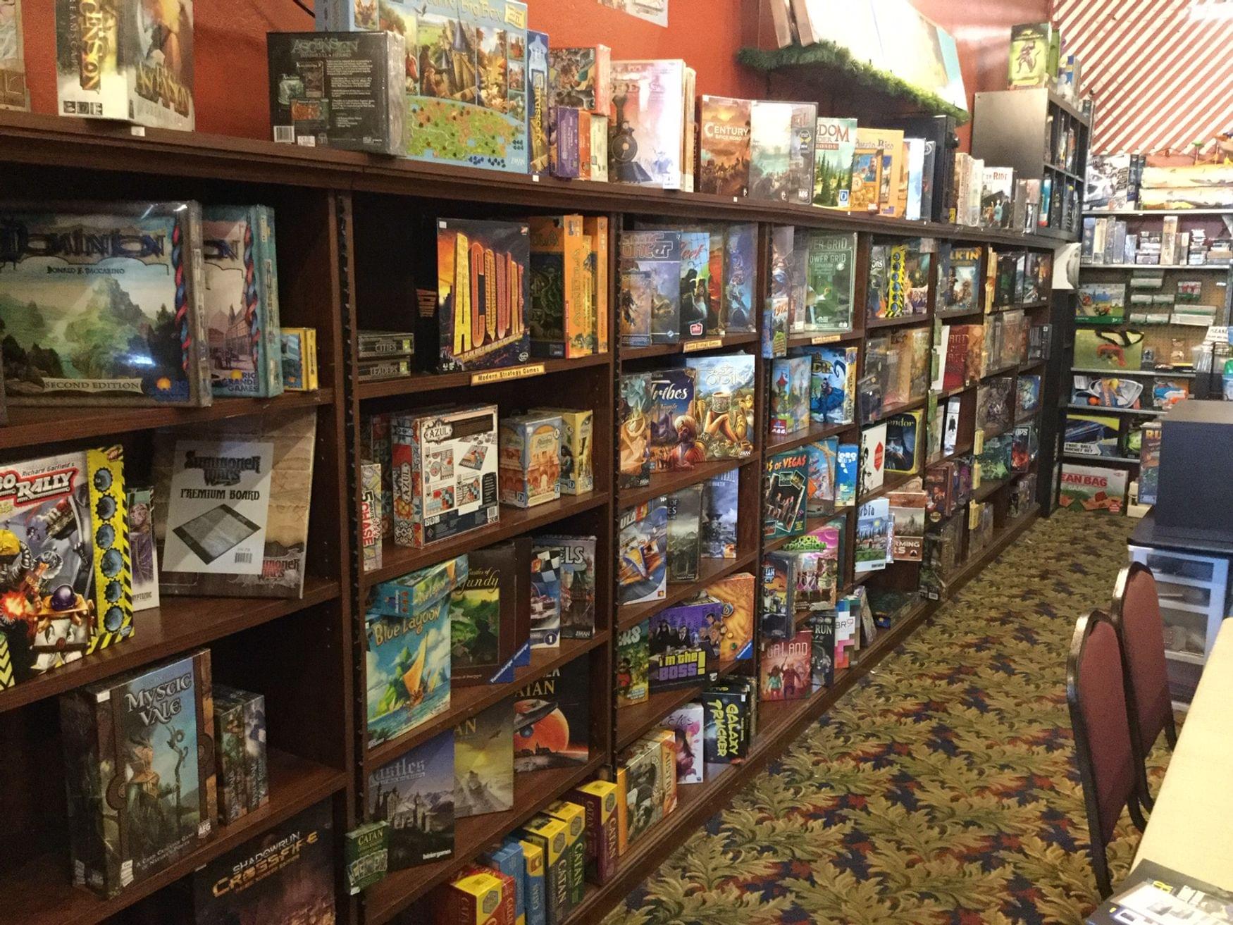 Spotlight On The Game Getaway A Game Store With A Wall Of Games